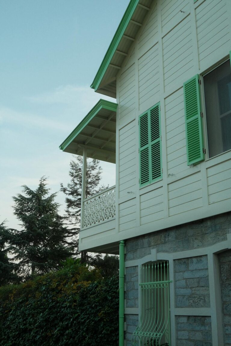 A charming house with green shutters under a clear sky in İstanbul.